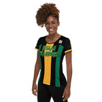A Jamaica football women's shirt in Jamaica flag colors of green, black, and yellow showing the left side of a black woman.