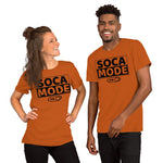 A black man and white woman wearing autumn color shirts that say Soca Mode in black print on the front.