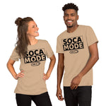 A black man and white woman wearing gold color shirts that says Soca Mode in black print on the front.